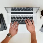 Laptop with user typing