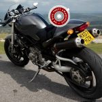 ducati monster motorcycle sat at a viewpoint